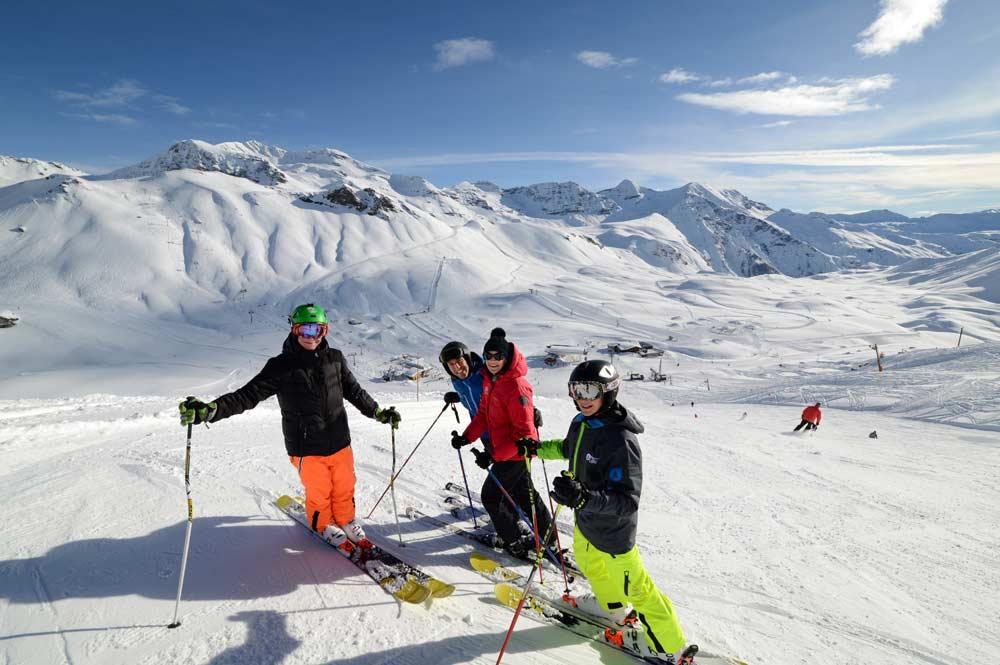 Vier Skifahrer mit Bergpanorama
